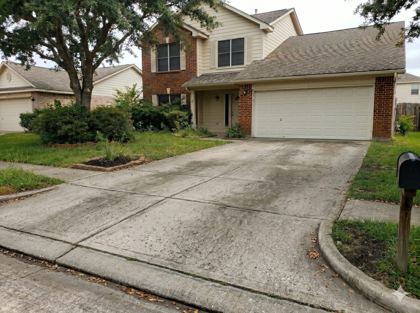 Concrete driveway before pressure washing — stained and dirty